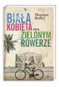 Biała kobieta na zielonym rowerze.